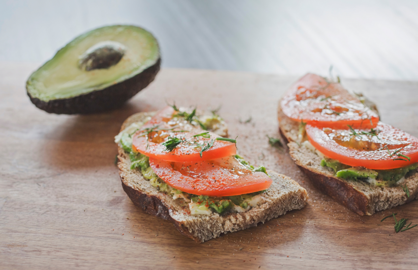 sourdough toast topped with avocado and tomatoes